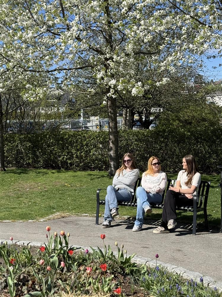 Tre personer på en benk under et tre - Klikk for stort bilde